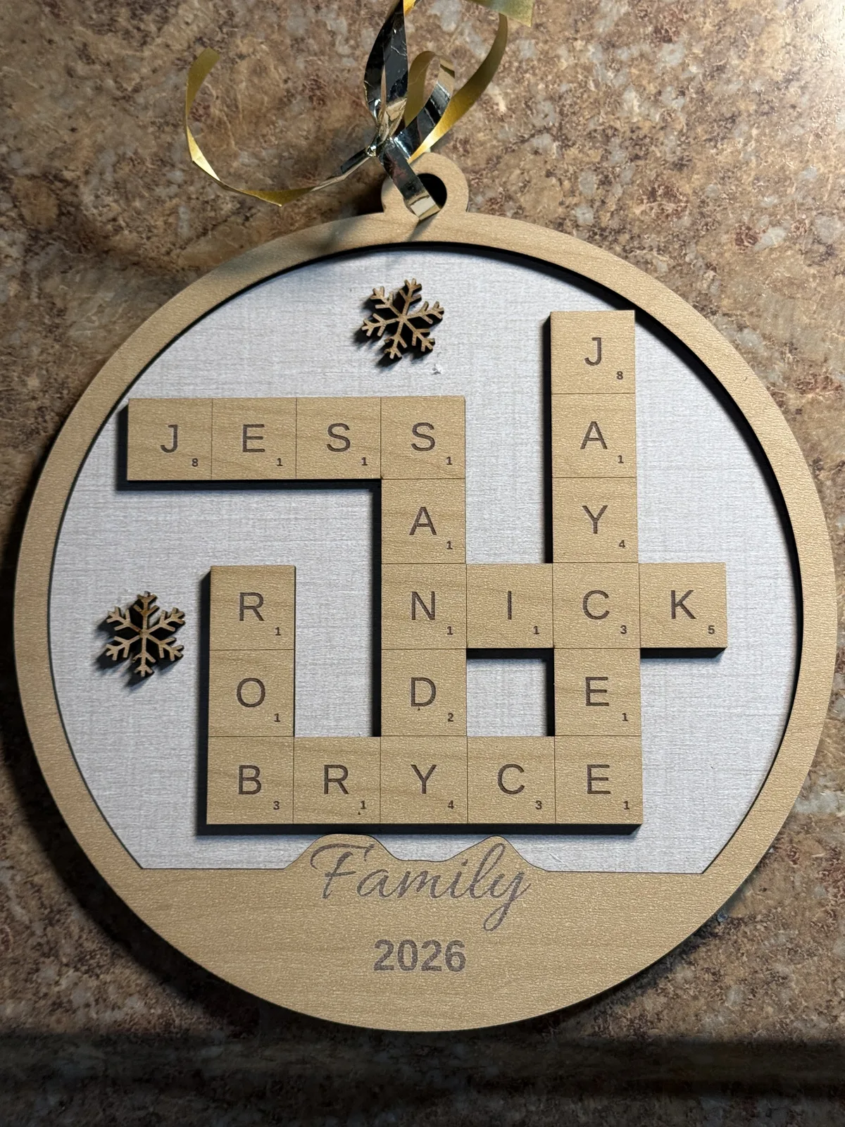 Finished personalized Family Crossword Ornament with snowflake decorations